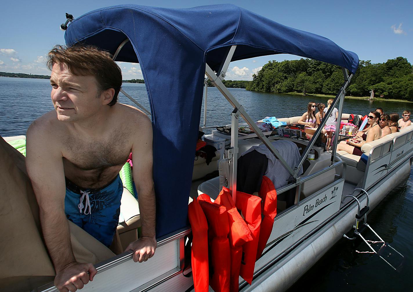 David Polley, Chaska, and his family rented a pontoon boat to celebrate the 14th birthday of his daughter, Olivia. ]JIM GEHRZ &#x201a;&#xc4;&#xa2; jgehrz@startribune.com / Excelsior, MN / July 3, 2014 / 11:00 AM / BACKGROUND INFORMATION: The July 4th weekend is usually the busiest weekend of the entire year for Lake Minnetonka and other Minnesota waterways. But not this year. Record flooding has forced unprecedented wake restrictions on lakes like Minnetonka, turning a usually raucous, crowded l