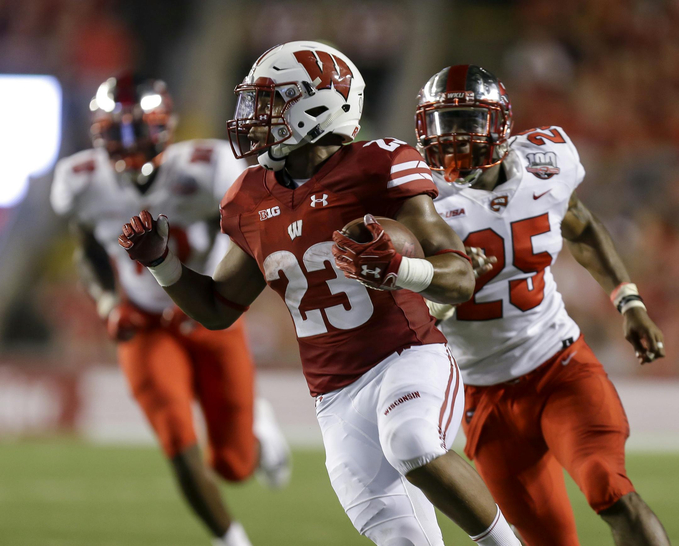 Wisconsin running back Jonathan Taylor runs for a touchdown as Western Kentucky linebacker Masai Whyte (25) give chase during the first half of an NCAA college football game Friday, Aug. 31, 2018, in Madison, Wis. (AP Photo/Andy Manis)