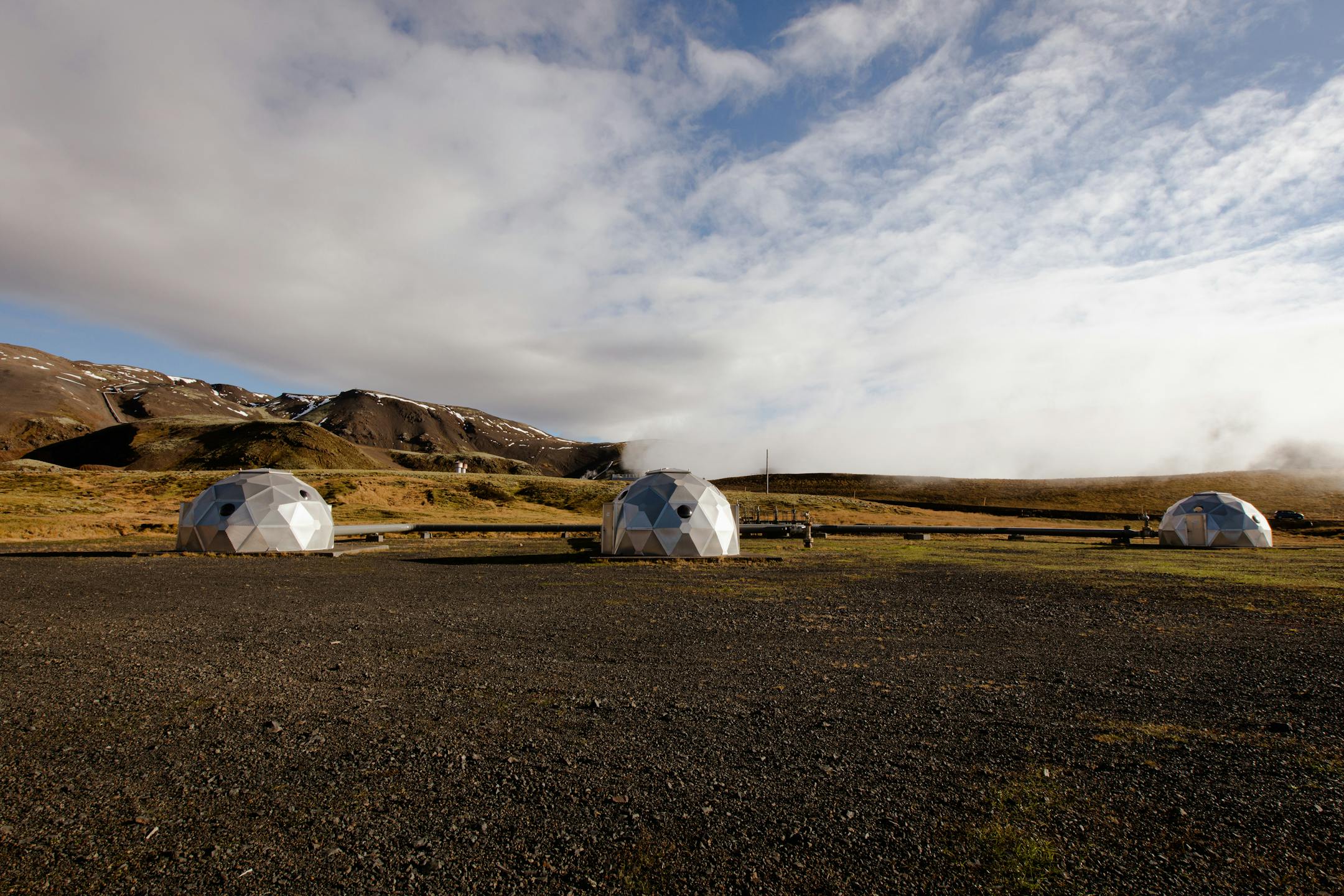 Steel igloos cover injection wells that the Icelandic start-up company Carbfix uses to inject carbon dioxide into the earth outside Reykjavik, Iceland, on Oct. 6, 2021. Carbfix has discovered that its CO2 mix will chemically react with basalt and turn to rock in just two or three years instead of the centuries that the mineralization process was believed to take. (Sigga Ella/The New York Times)