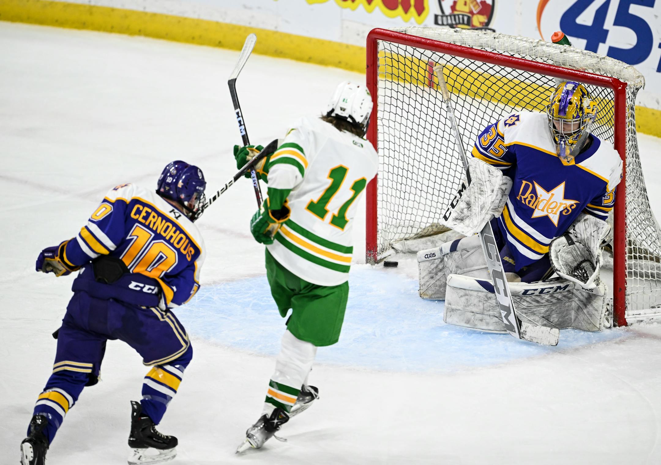 Edina forward Ryan Flaherty (11) scores a goal against Cretin-Derham Hall goaltender Leo Miller (35) during the third period.