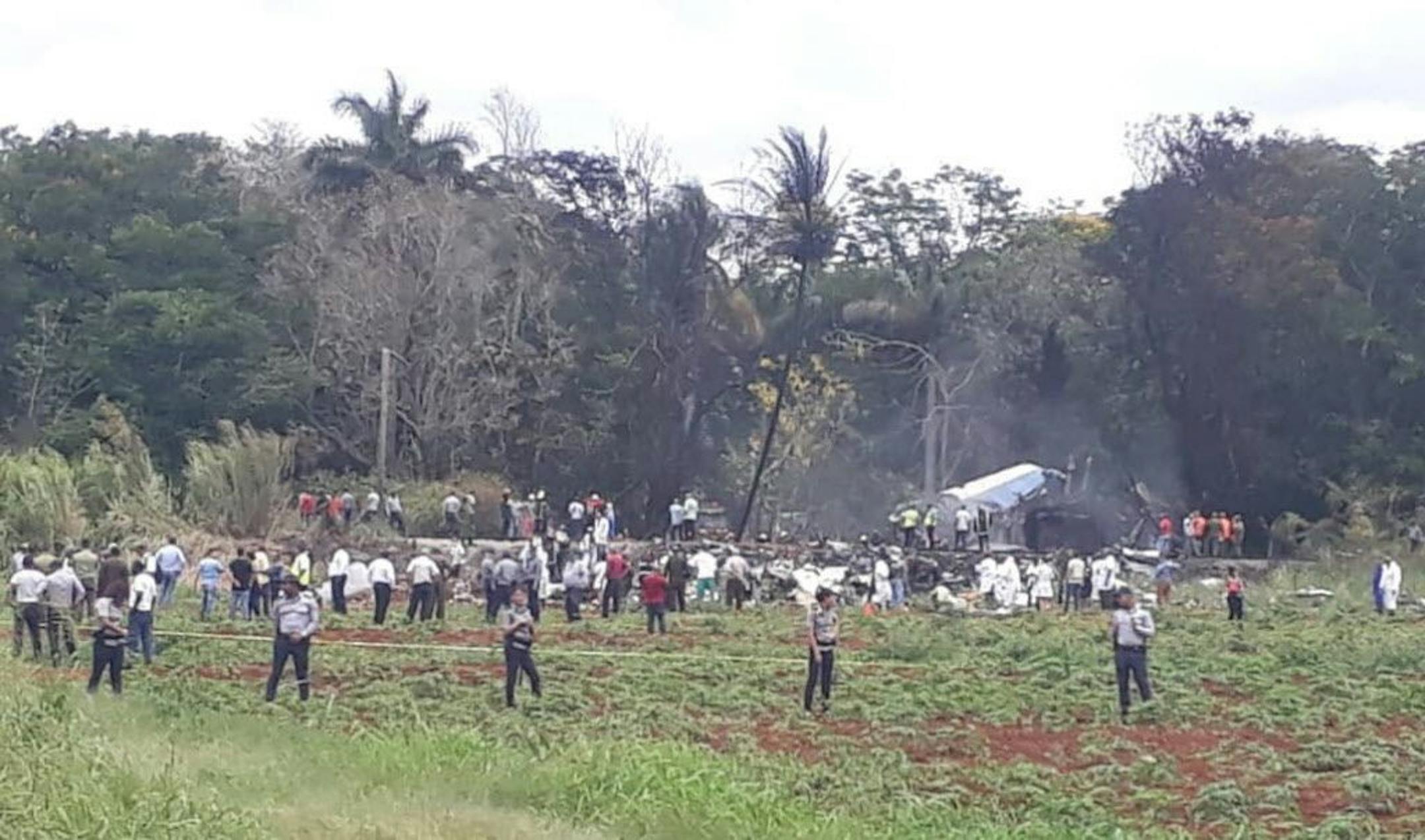 Rescue and search workers on the site where a Cuban airliner with 104 passengers on board plummeted into a yuca field just after takeoff from the international airport in Havana, Cuba, Friday, May 18, 2018.