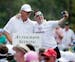 Ernie Els, left, of South Africa, poses with a spectator during the Par 3 contest at the Masters golf tournament Wednesday, April 8, 2015, in Augusta,