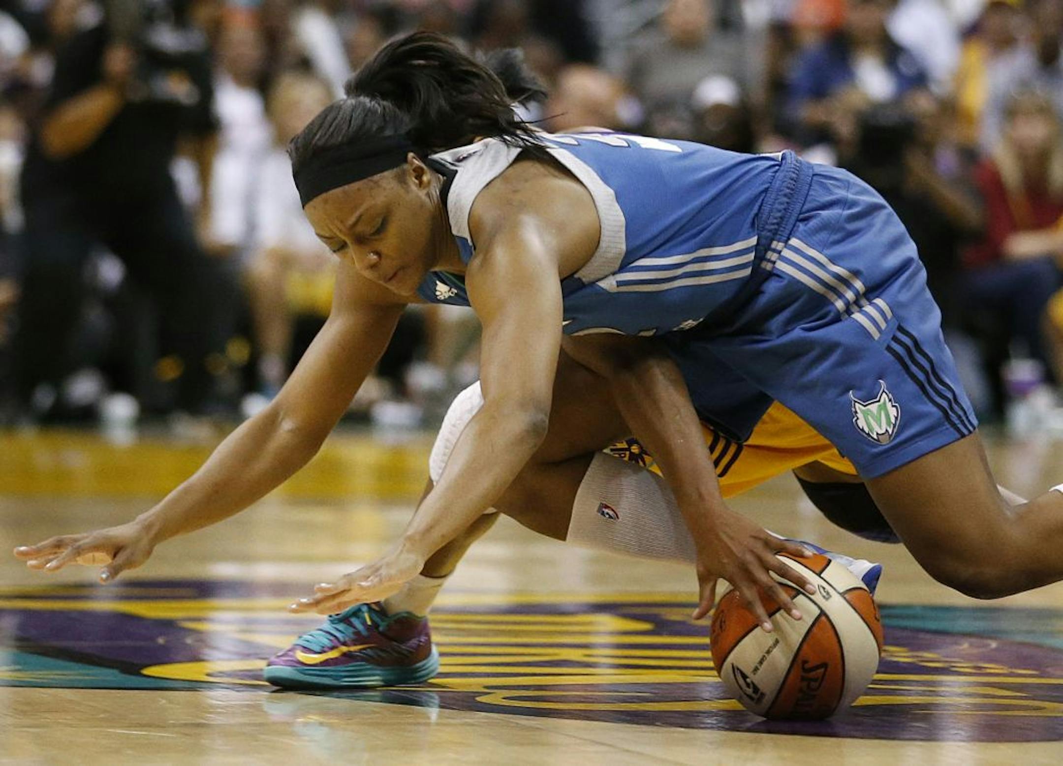 The Lynx's Monice Wright, top, found herself open for a three-pointer with just over one minute to play in Sunday's Game 2 of the Western Conference finals against the Los Angeles Sparks. Her basket proved the difference in the 80-79 victory.