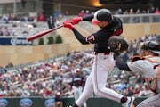 Twins second baseman Edouard Julien fouls off a pitch before getting walked by Tigers pitcher Reese Olson in the first inning Saturday.