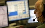 A 911 operator answered emergency calls at a Minneapolis dispatch center in 2017. An hourlong outage Thursday, Aug. 2, affected service across the sta