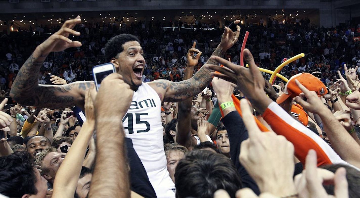 Miami's Julian Gamble celebrates with fans after defeating Duke 90-63 in an NCAA college basketball game in Coral Gables, Fla., Wednesday, Jan. 23, 2013. (AP Photo/The Miami Herald, Charlie Trainor) MAGS OUT