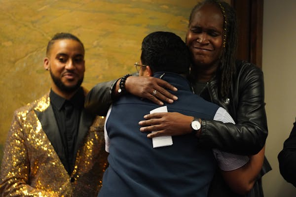 Council Member Phillipe Cunningham, who says he survived conversion therapy stood by as Roger Sanchez, a survivor of conversion therapy hugged Council