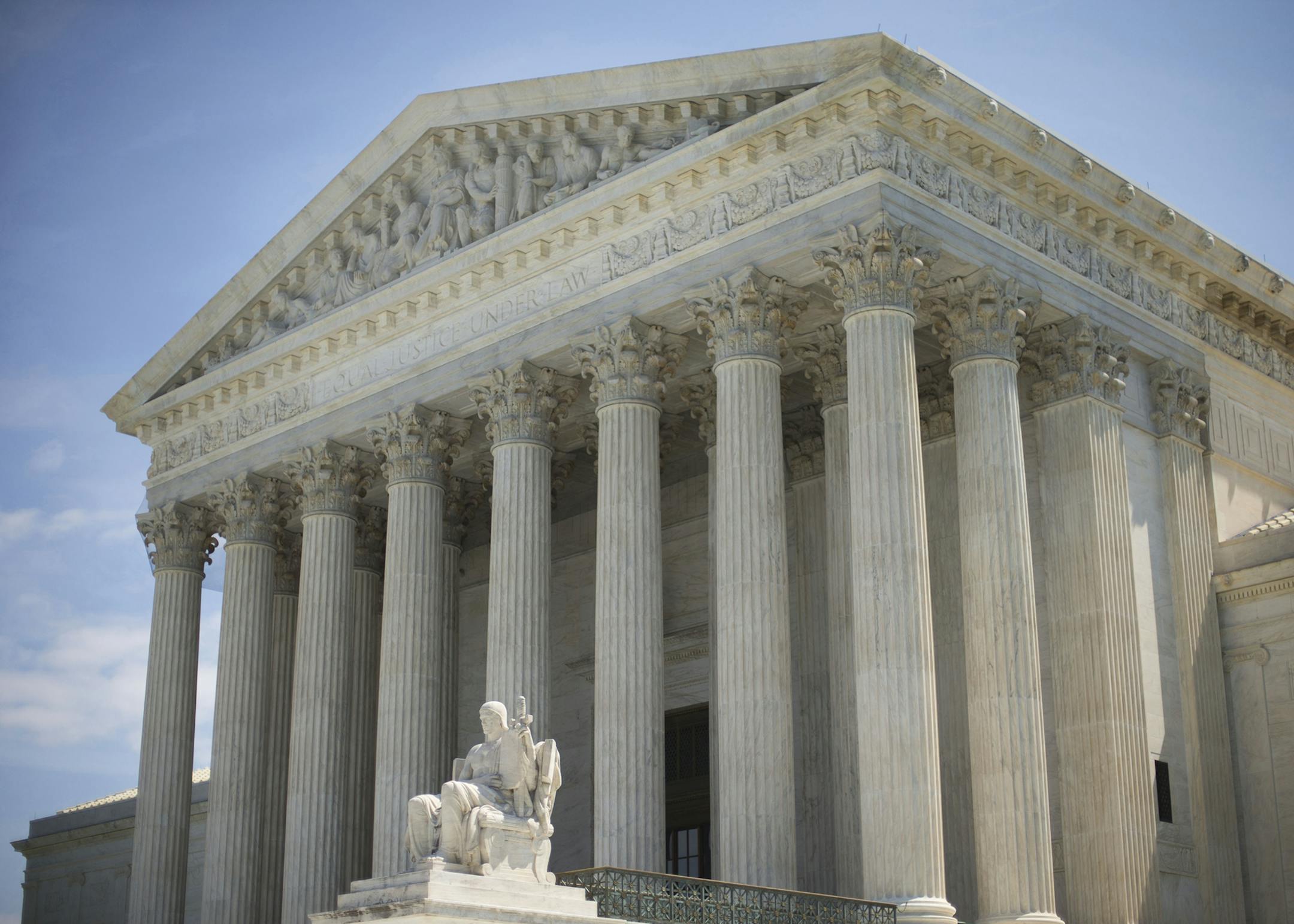 The Supreme Court building following the court's decision on the Hobby Lobby case in Washington, Monday, June 30, 2014. The Supreme Court says corporations can hold religious objections that allow them to opt out of the new health law requirement that they cover contraceptives for women.(AP Photo/Pablo Martinez Monsivais) ORG XMIT: MIN2014070112043417