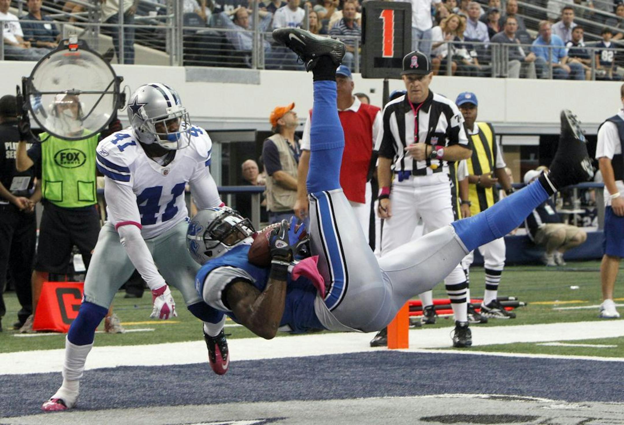 Detroit Lions wide receiver Calvin Johnson makes a 2-yard touchdown reception as Dallas Cowboys cornerback Terence Newman defends during the second half of an NFL football game Sunday, Oct. 2, 2011, in Arlington, Texas. Cowboys won 34-30.