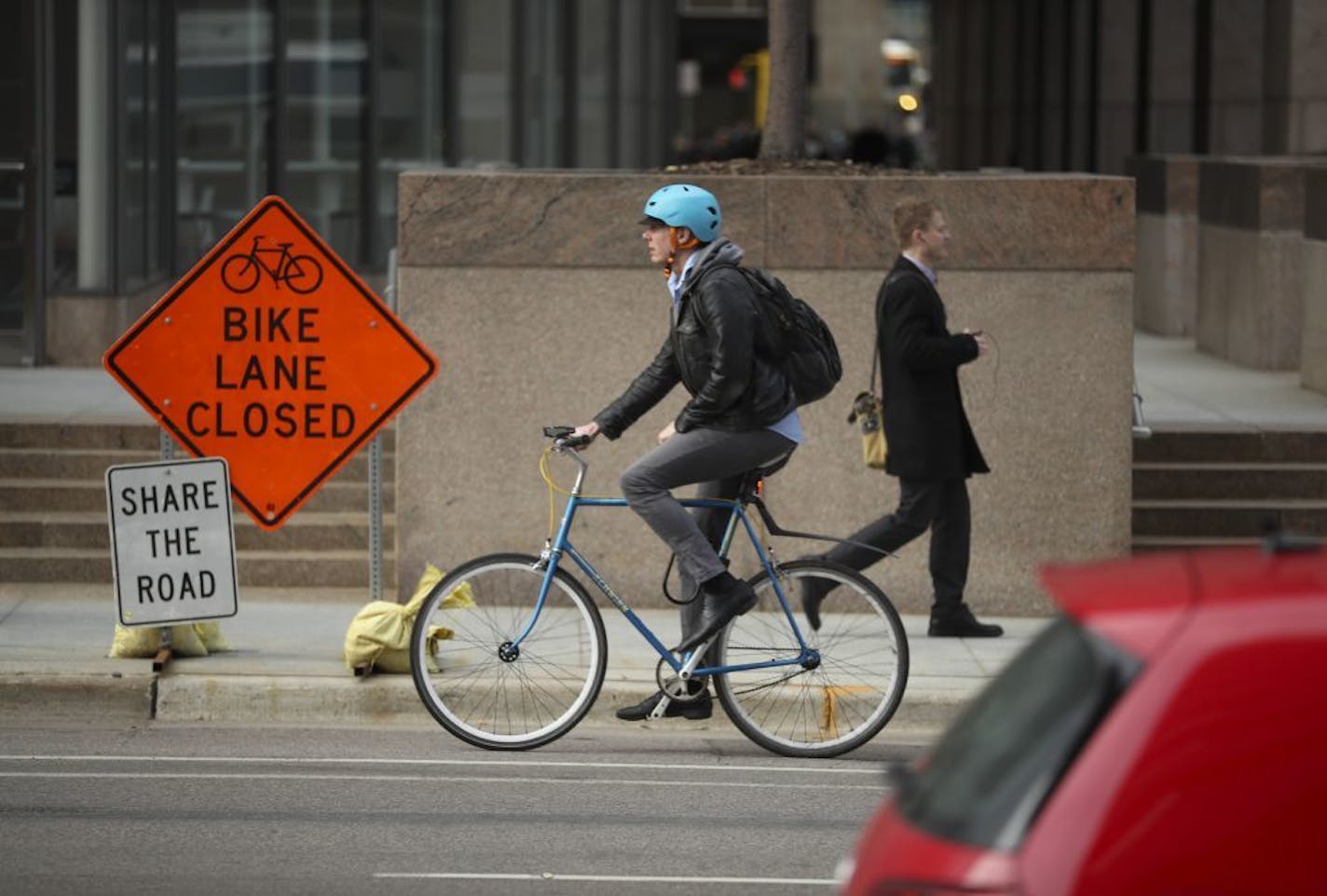 A cyclist used the bike lane on 3rd Ave. S., which was not closed, Monday afternoon.