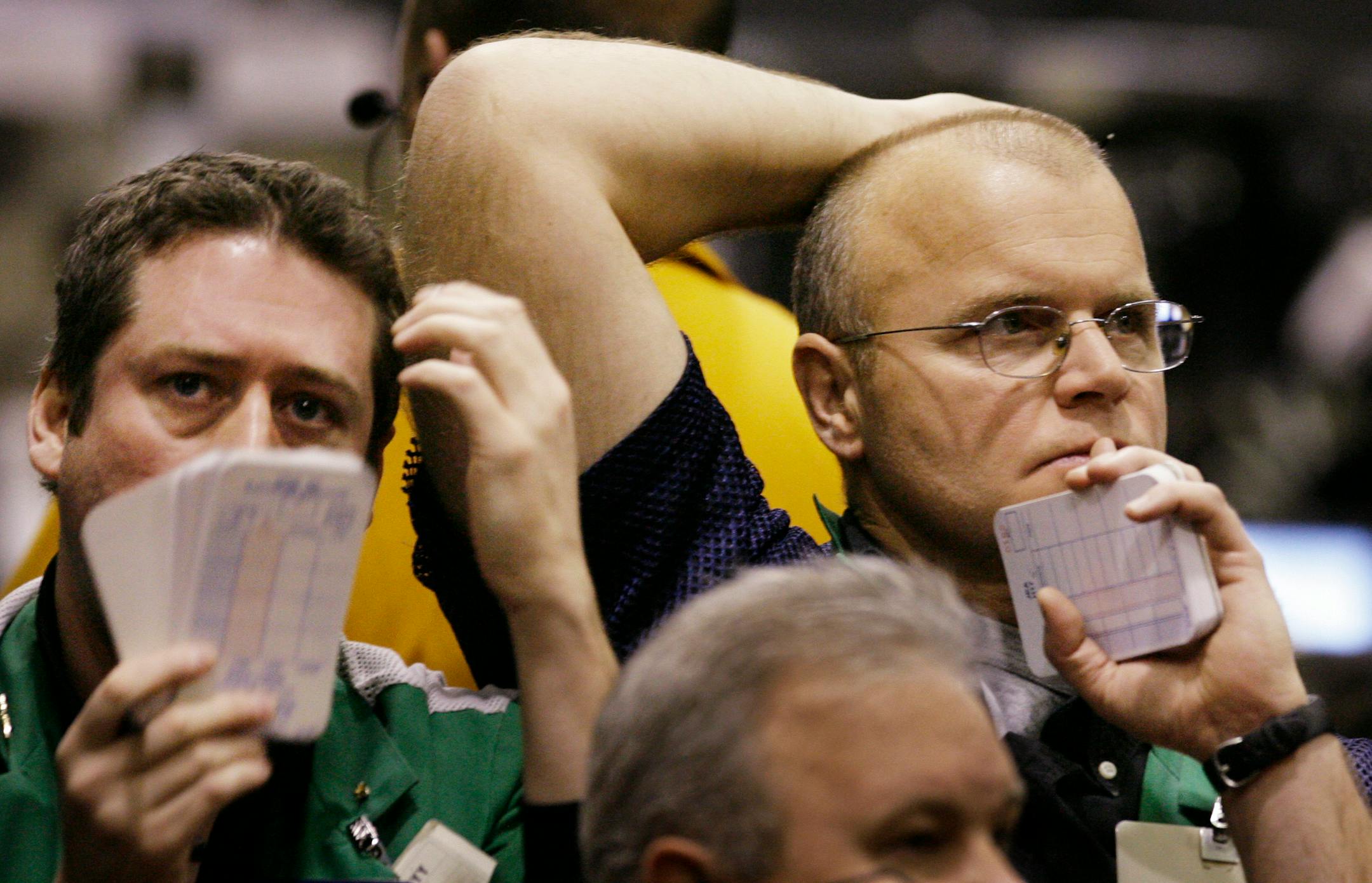 Kevin Maloney, left, and John Allen react to the markets in the S&P 500 futures trading pit Tuesday at the Chicago Mercantile Exchange.