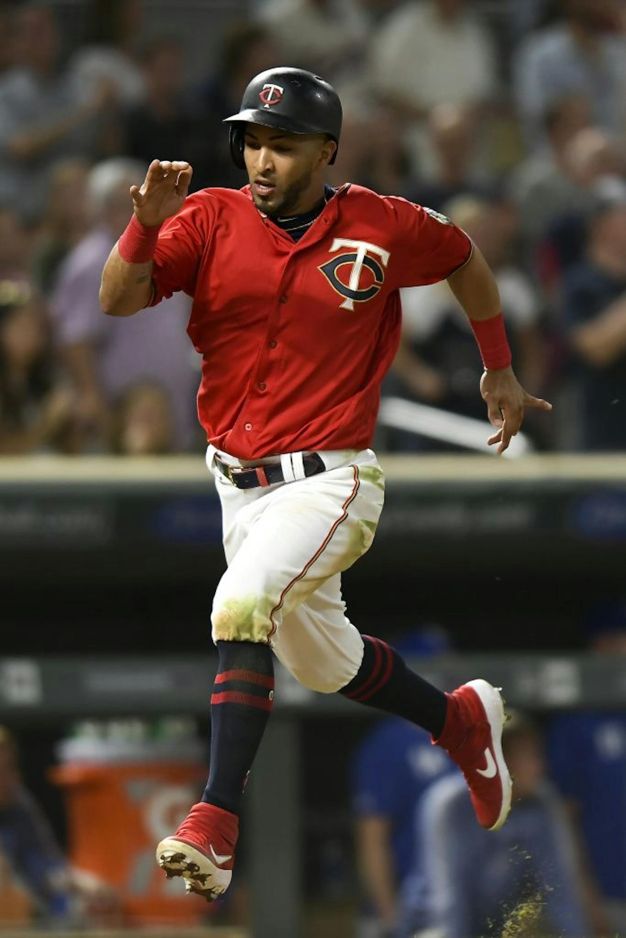 Minnesota Twins left fielder Eddie Rosario (20) scored a run off a double by third baseman Miguel Sano (22) in the bottom of the fifth inning against the Kansas City Royals.