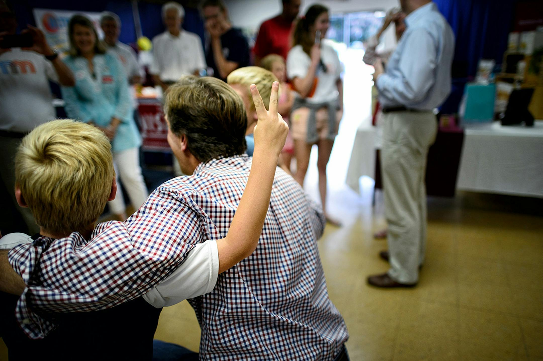 Eight-year-old twins Jacob and Noah Thompson couldn't resist the opportunity to use his fingers to make bunny ears behind Mike McFadden's head while getting their picture taken with him at the Republican display at the Waseca County Free Fair, Wednesday, July 16, 2014. ] GLEN STUBBE * gstubbe@startribune.com