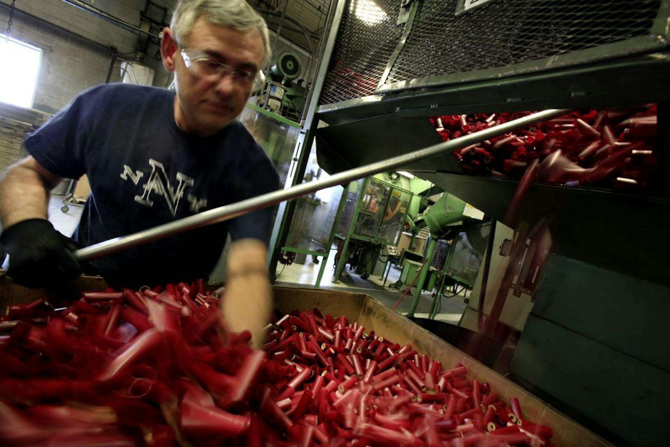 Jorge Vargas of Alliant Techsystems unloads a hopper of shell casings. Each hopper holds 80,000 shells.