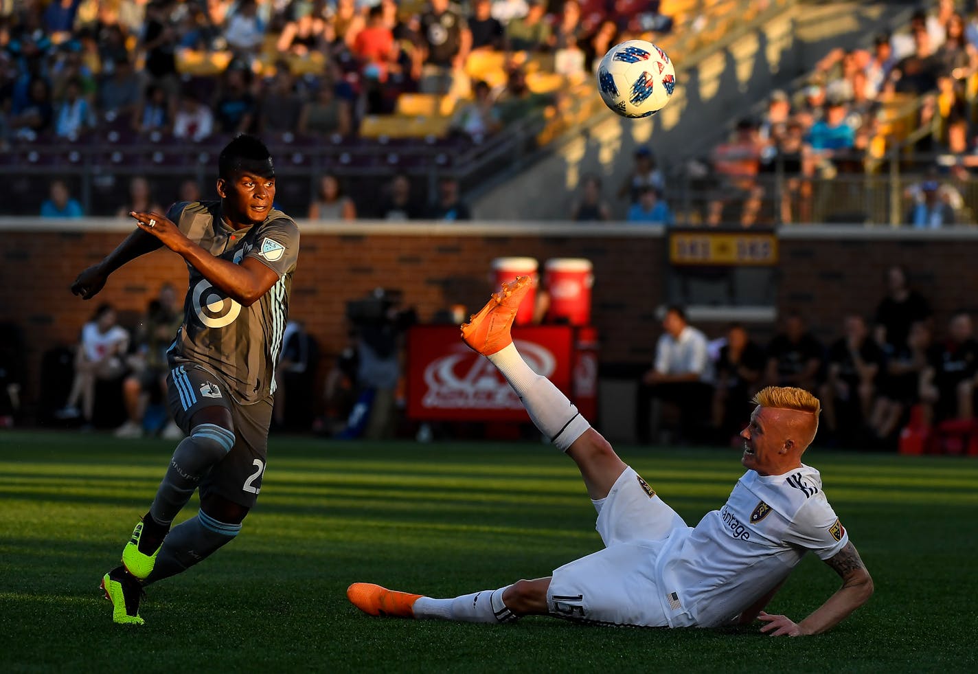 Real Salt Lake defender Justen Glad (15) falls to his back as Minnesota United forward Carlos Darwin Quintero (25) eyes the ball in the second half