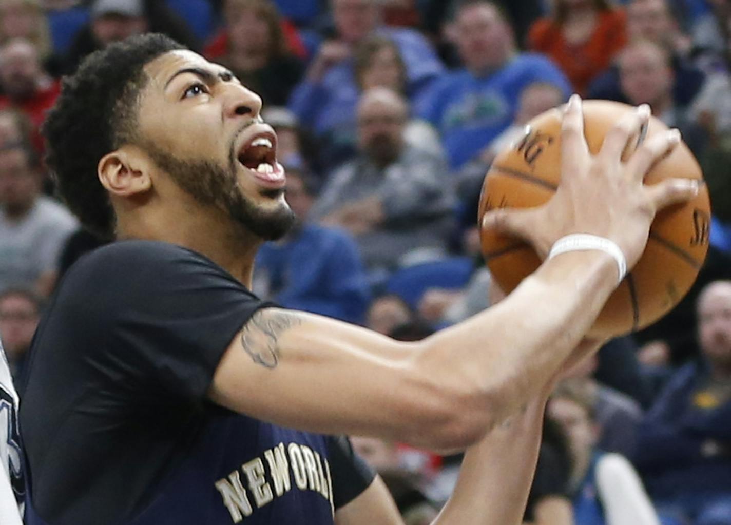 New Orleans Pelicans' Anthony Davis, right, lays up as Minnesota Timberwolves' Kris Dunn defends during the second half of an NBA basketball game Friday, Feb. 10, 2017, in Minneapolis. The Pelicans won 122-106. Davis led the Pelicans with 42 points and 13 rebounds. (AP Photo/Jim Mone)