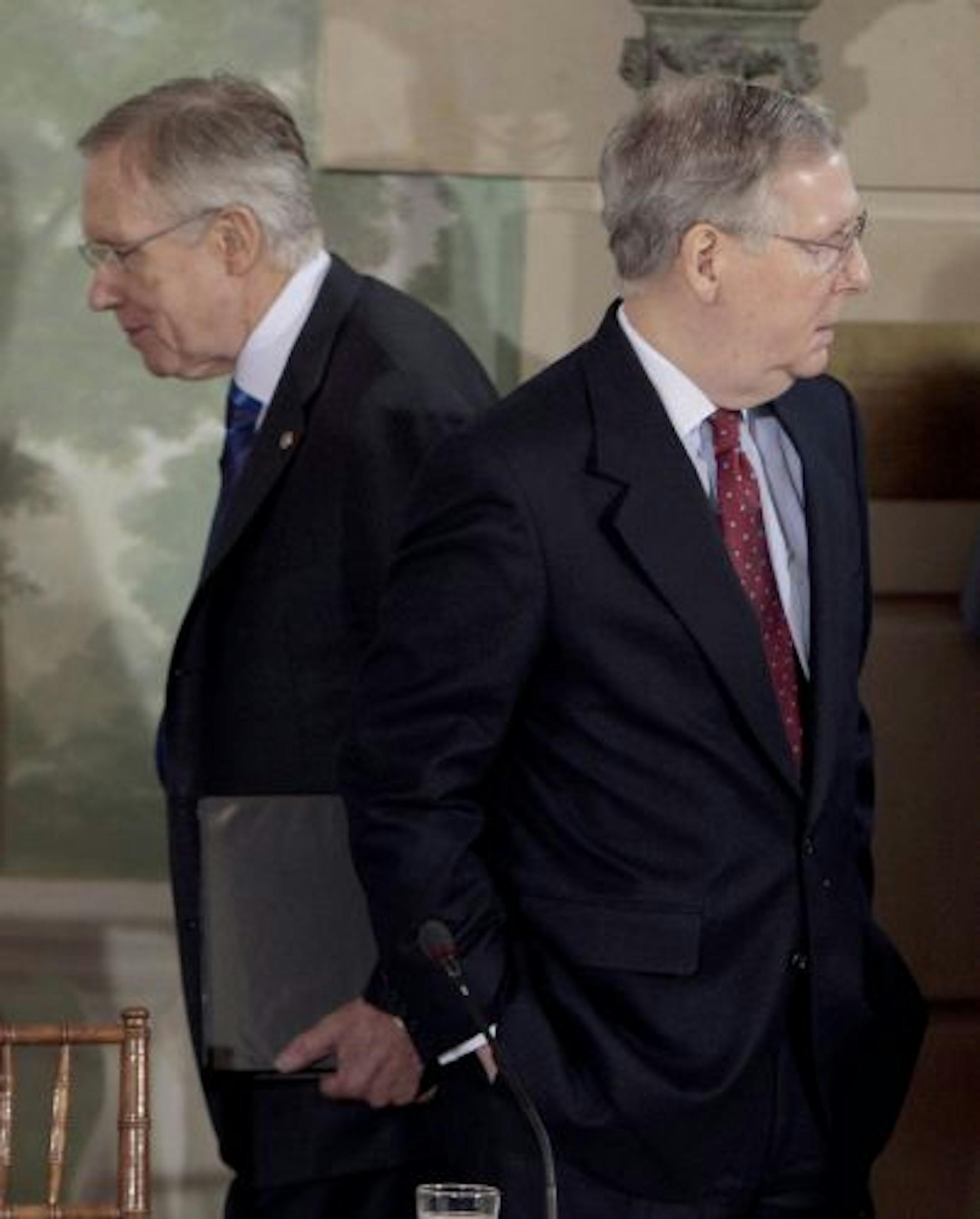Senate Majority Leader Harry Reid of Nev., left, walks past Senate Minority Leader Mitch McConnell of Ky.