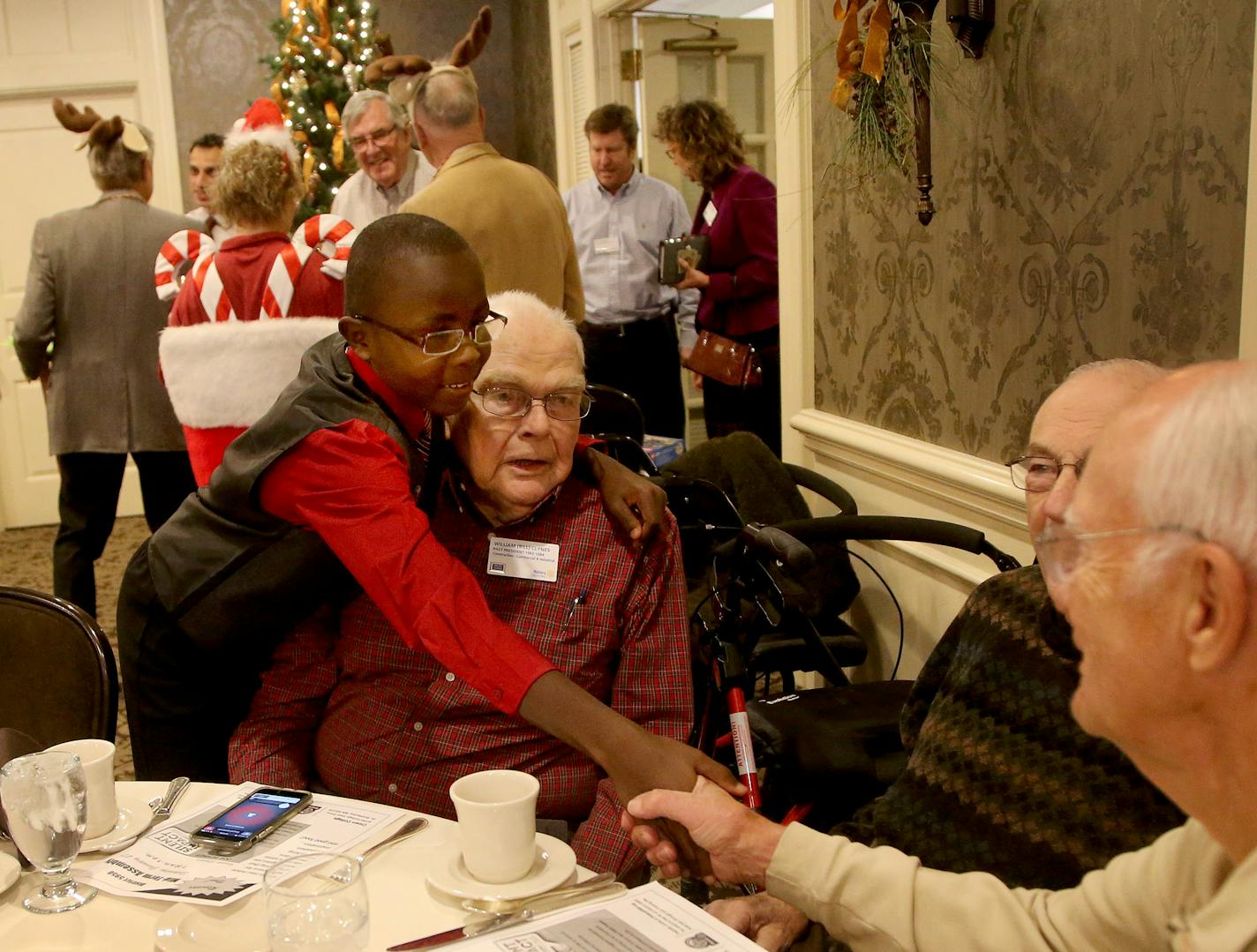 The Edina Rotary Club is having a 13th birthday celebration for Moses Mwaura, the young Kenyan boy they sponsored, who received corrective eye and teeth surgery and who is back in Edina for the first time in 7 years. Here, Moses, puts his arms around Rotarian Bill Clynes while meeting other Rotarians Thursday, Dec. 7, 2017, at the Edina Country Club in Edina, MN.] DAVID JOLES &#x2022; david.joles@startribune.com In 2010, the Edina Rotary Club sponsored a boy from Kenya to come to Edina and recei