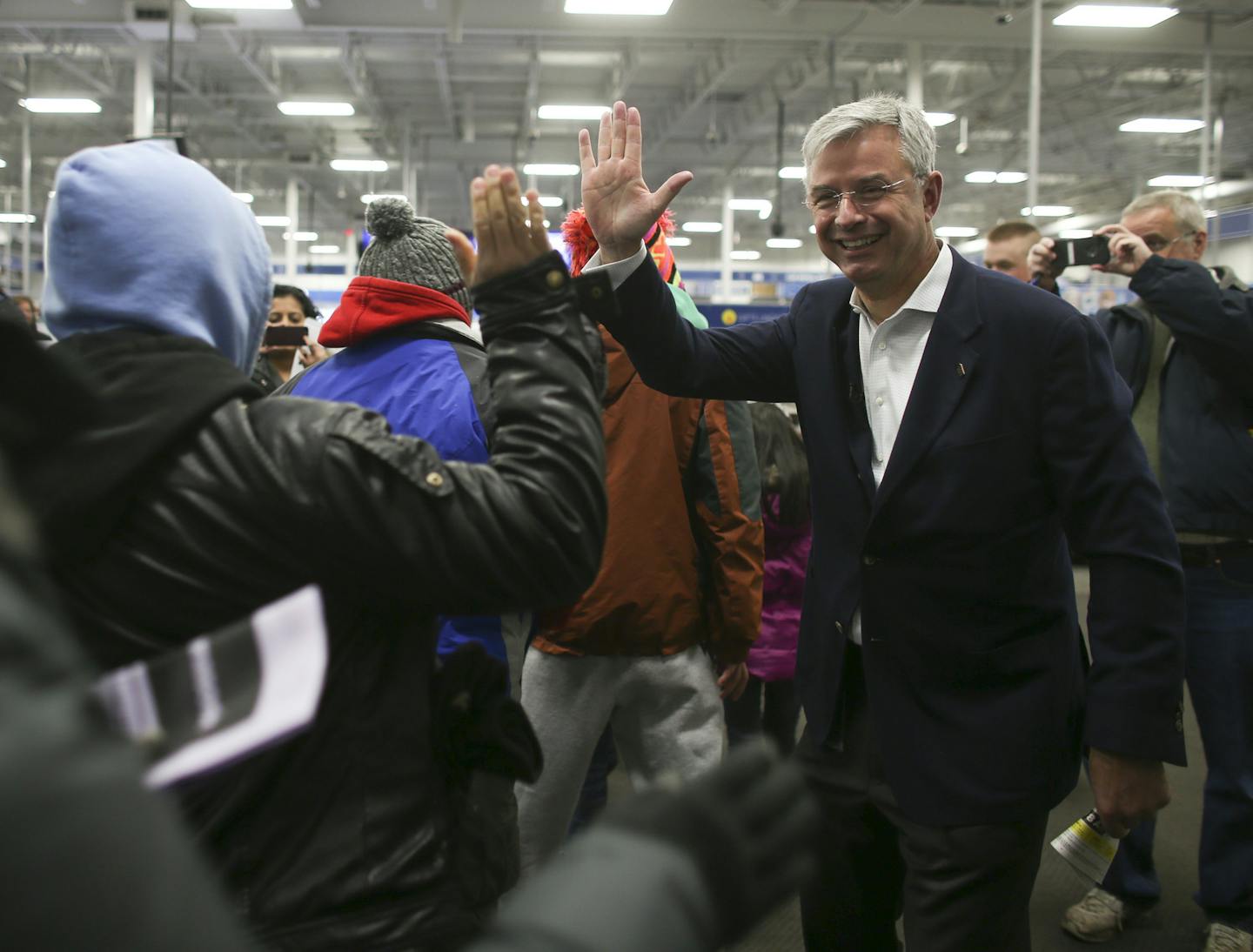 Best Buy CEO Hubert Joly high-fived customers as they entered the store to begin their holiday shopping on Thanksgiving night 2014.