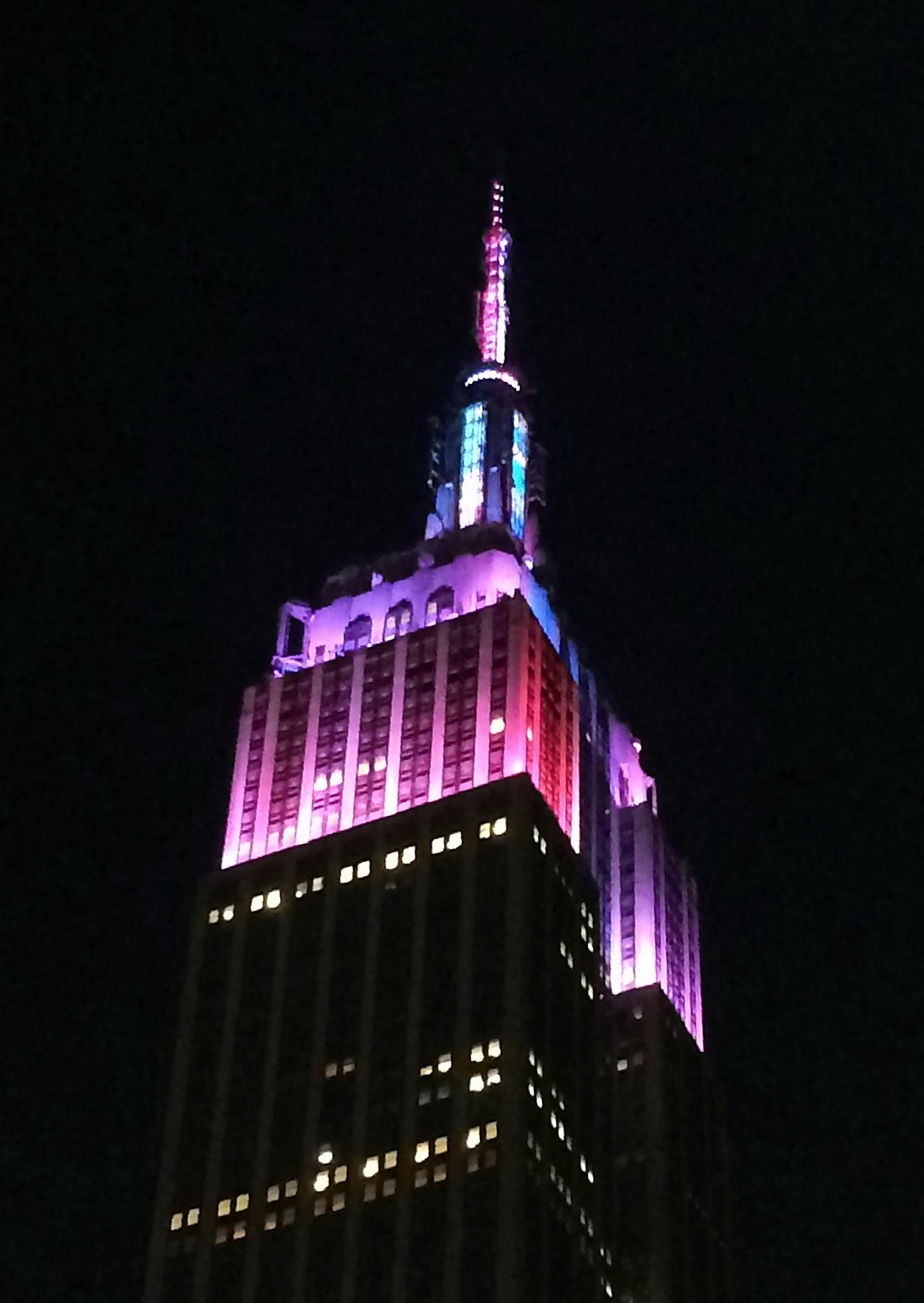 The top of the Empire State Building shines with red, white and blue lights on July 4, 2014, in New York City.
