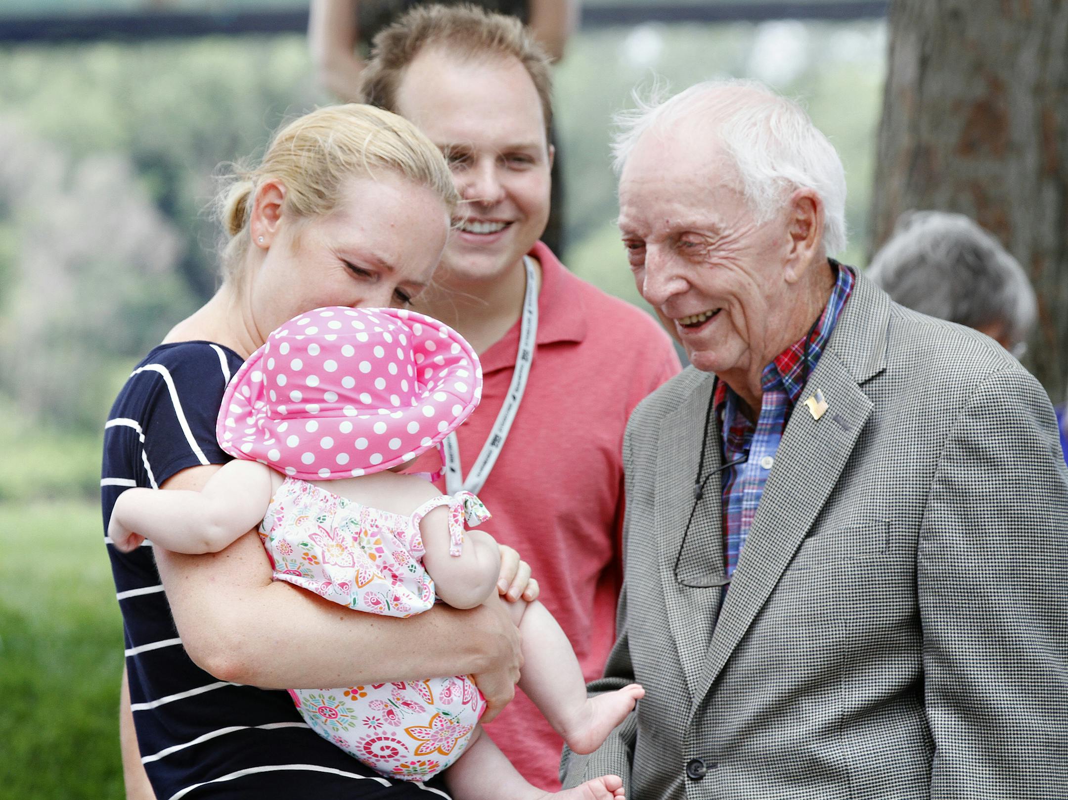 FILE - In this July 20, 2014, file photo, United Airlines flight 232 Capt. Al Haynes, right, smiles as he visits with survivors and family members following a remembrance service held in conjunction with the 25th Anniversary of the United Airlines flight 232 crash in Sioux City, Iowa. Haynes, a pilot credited for saving the lives of nearly 200 people by guiding the damaged passenger jet into a crash landing at an Iowa airport in 1989, has died. Haynes died Sunday, Aug. 25, 2019 at age 87 in a Se