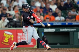 The Twins' Jose Miranda hits a go-ahead RBI double against the Astros' Ryan Pressly during the eighth inning Sunday in Houston.