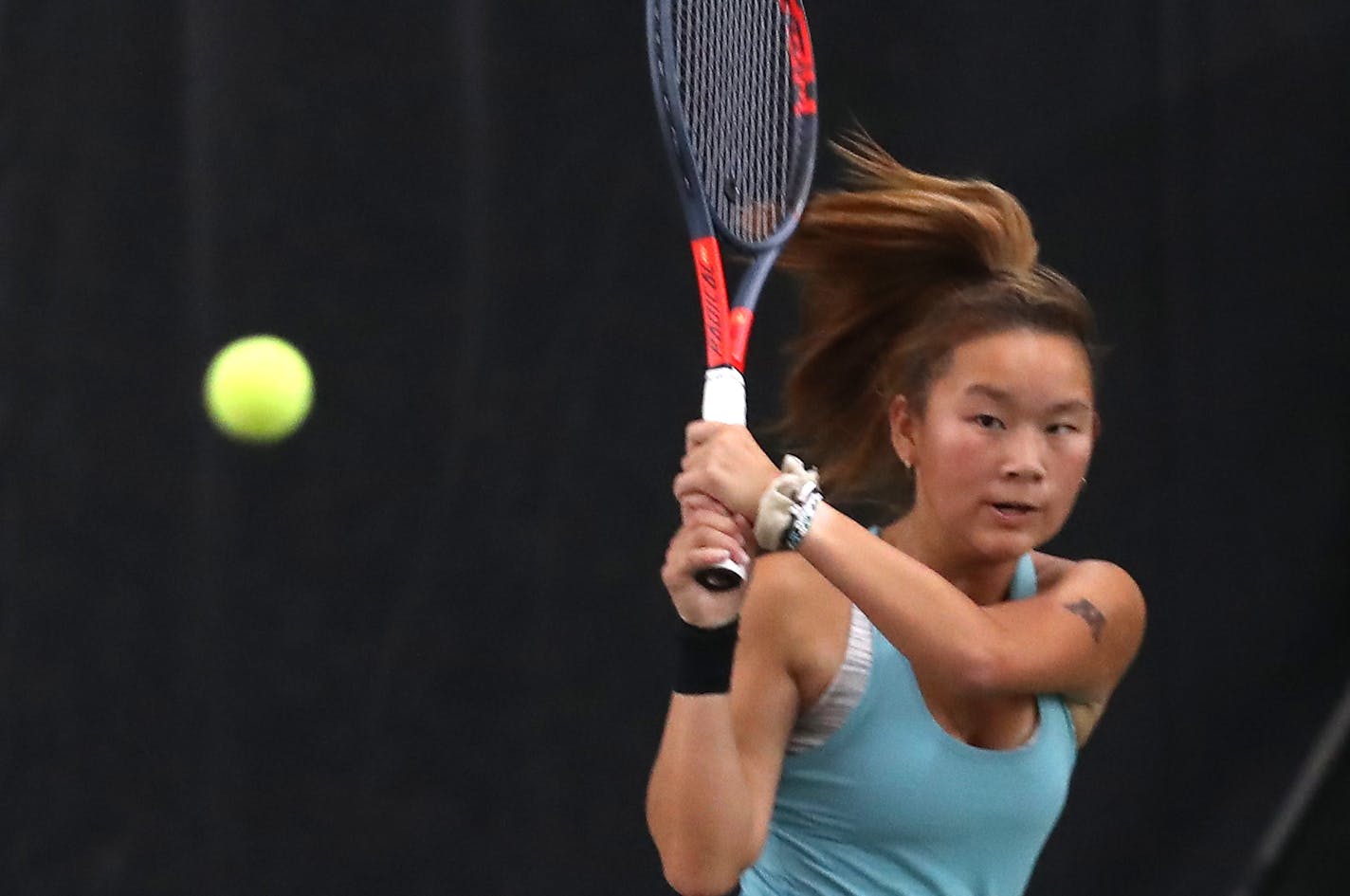 Minnetonka High's Sarah Shahbaz hits a backhand during on route to winning her match over Zoe Adkins of Maple Grove High