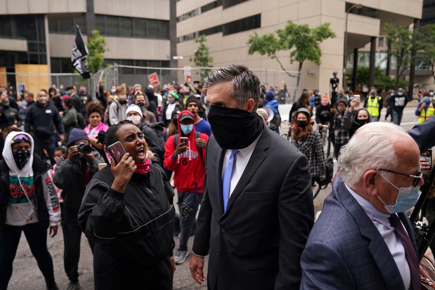 Former Minneapolis police officer Thomas Lane was screamed at by protesters as he walked to a car from the Hennepin County Family Justice Center following a hearing on several pending motions in the cases against four former officers in the killing of George Floyd. ] ANTHONY SOUFFLE • anthony.souffle@startribune.com A judge heard oral arguments on several pending motions in the cases against four former officers in the killing of George Floyd, including motions to dismiss the cases, Friday, Sept