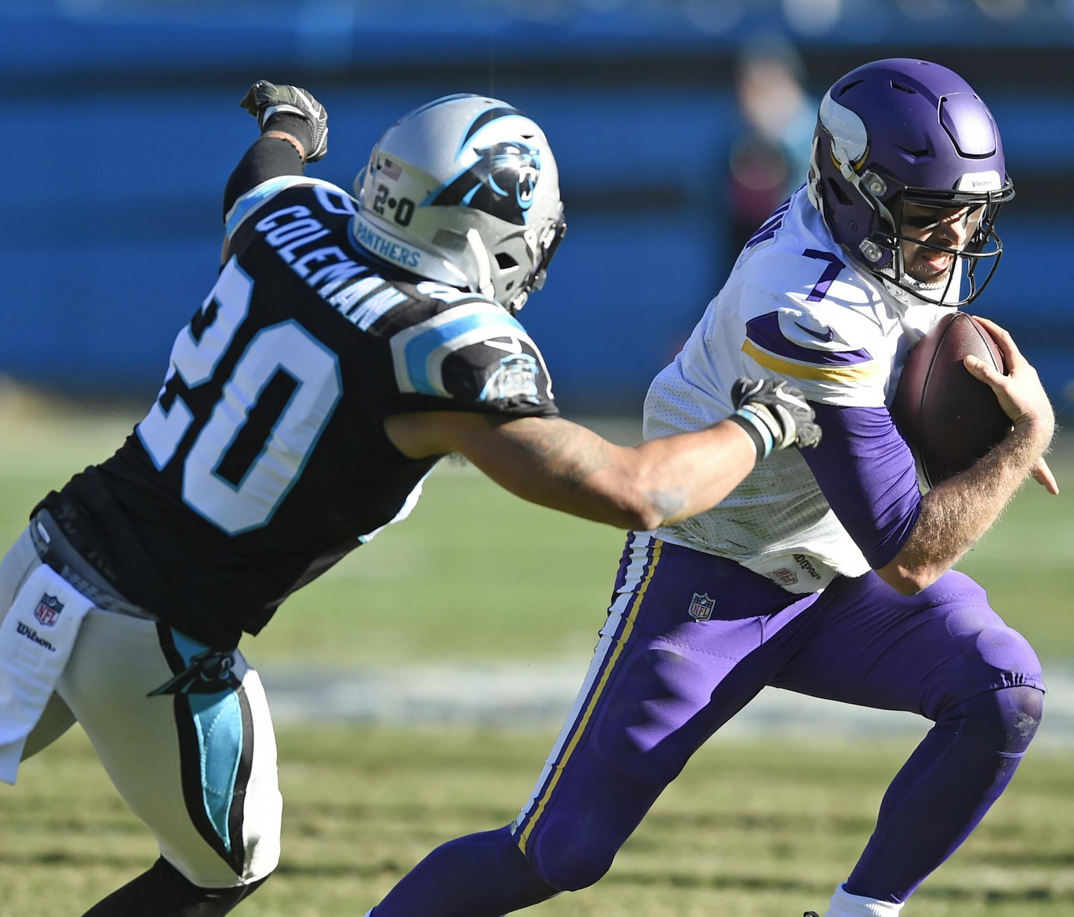 Minnesota Vikings' Case Keenum (7) runs past Carolina Panthers' Kurt Coleman (20) during the first half of an NFL football game in Charlotte, N.C., Sunday, Dec. 10, 2017. (AP Photo/Mike McCarn)