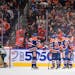 Oilers players celebrate a goal against the Wild during Friday's first period