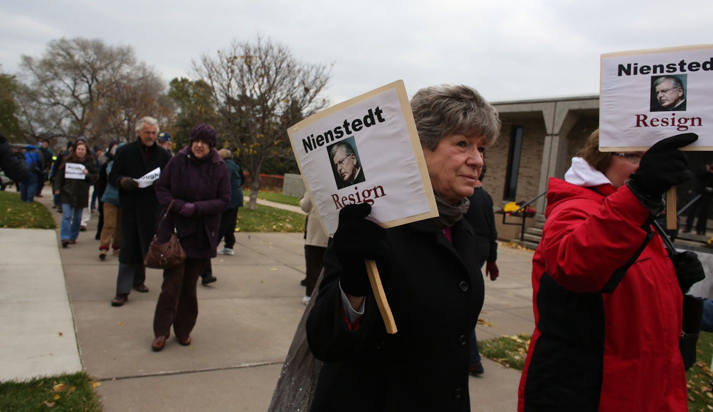 Diane Plocher, of Mayer, braved the cold and wind along with other protesters to march for the resignation of Archbishop John Nienstedt across the street from the Cathedral of St. Paul in St. Paul, Min., Saturday, November 9, 2013. Plocher's son Shawn was a victim of abuse in the 80s.