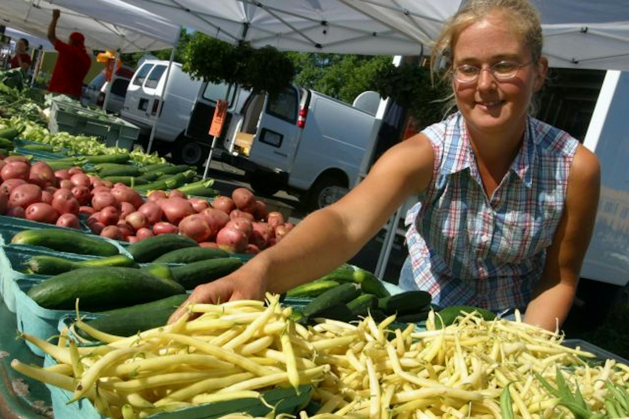 Julie Pflaum of Pflaum Farms in Farmington prepared for another day of selling fresh vegetables at the Lake Street Midtown Farmers Market, which is vying to be named the nation's best market.