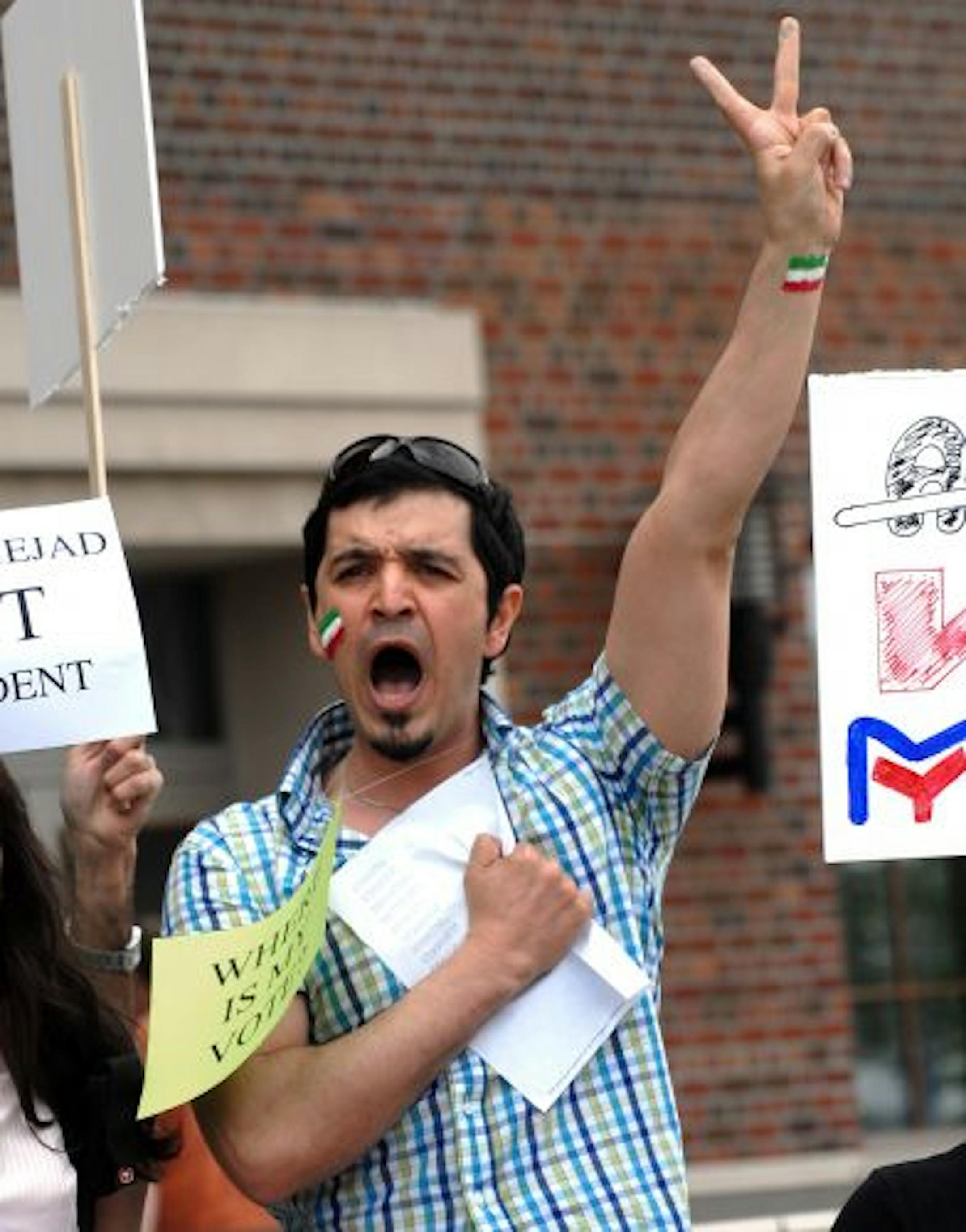 Mohammad Ebtehaj shouted political slogans with the Iranian flag painted on his wrist and face. About 50 Iranian students held a peaceful rally outside of Coffman Memorial Union on Monday at noon to show support for those protesting in Iran.