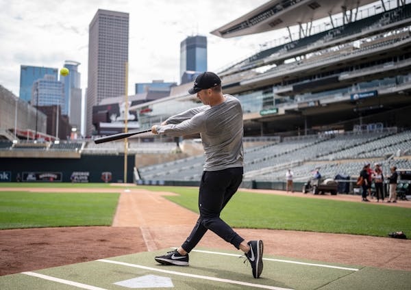 Former Minnesota Twin Joe Mauer hit a softball down the first base line at Target Field.