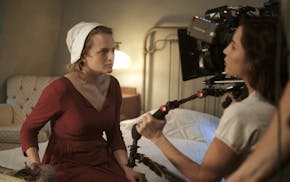 The Handmaid's Tale -- "Late" Episode 103 -- Offred visits Janine&#x2019;s baby with Serena Joy and remembers the early days of the revolution before 