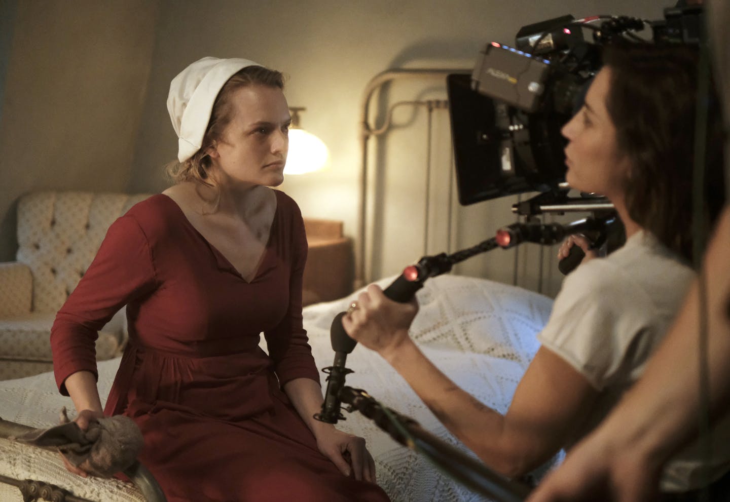 The Handmaid's Tale -- "Late" Episode 103 -- Offred visits Janine&#x2019;s baby with Serena Joy and remembers the early days of the revolution before Gilead. Ofglen faces a difficult challenge. Behind the scenes with Offred (Elisabeth Moss) and Reed Morano, shown. (Photo by: George Kraychyk/Hulu) ORG XMIT: Season 1