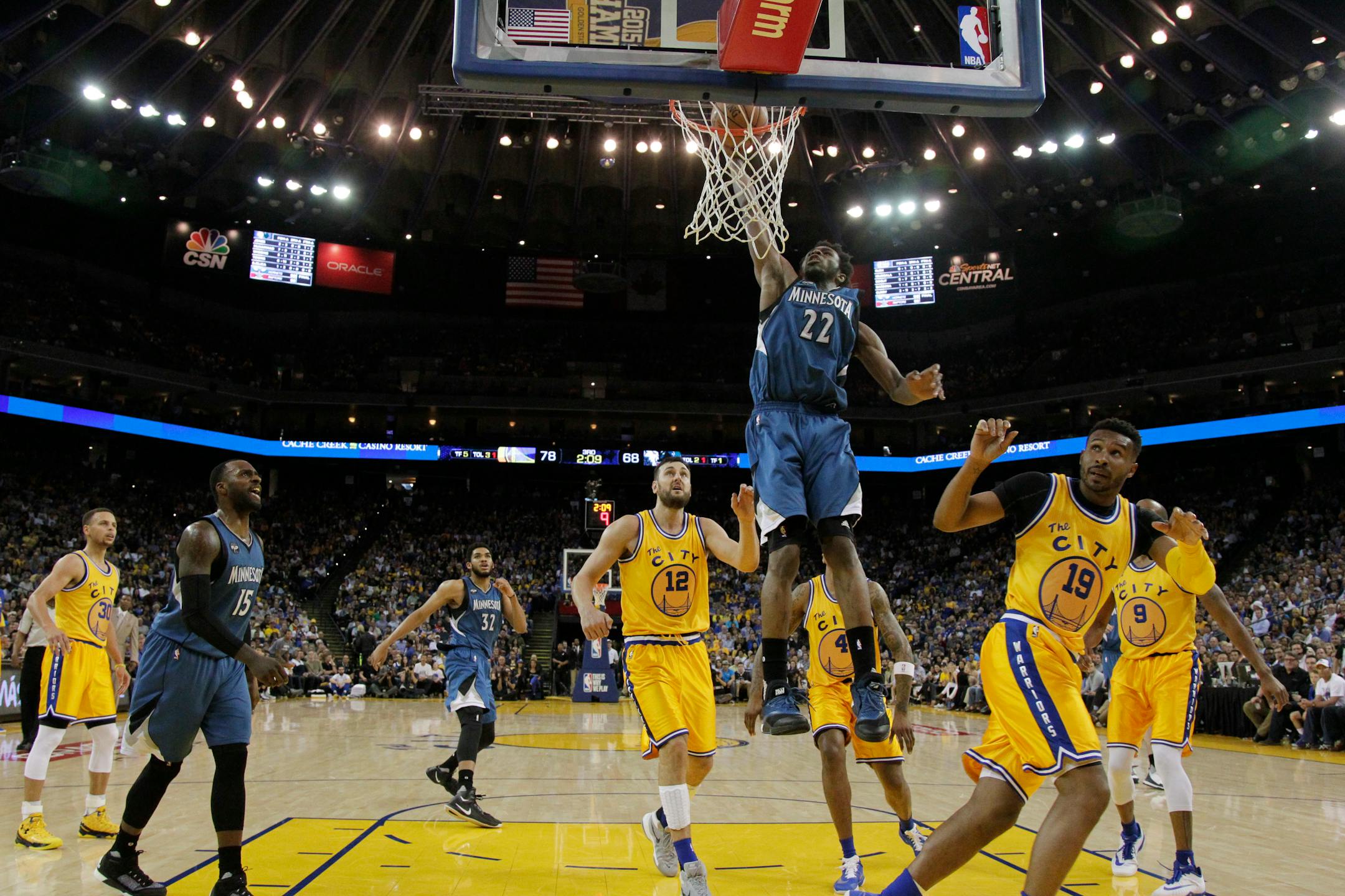 Minnesota Timberwolves' Andrew Wiggins (22) dunks against the Golden State Warriors during the second half of an NBA basketball game Tuesday, April 5, 2016, in Oakland, Calif. Minnesota won 124-117 in overtime. (AP Photo/Marcio Jose Sanchez)
