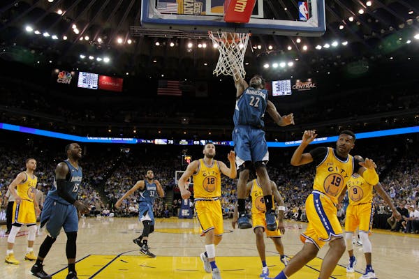 Minnesota Timberwolves' Andrew Wiggins (22) dunks against the Golden State Warriors during the second half of an NBA basketball game Tuesday, April 5,