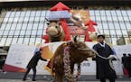 A farmer parades with a bull during the opening of this year's trading at the Korea Exchange in Seoul, South Korea, Tuesday, Jan. 2, 2018.