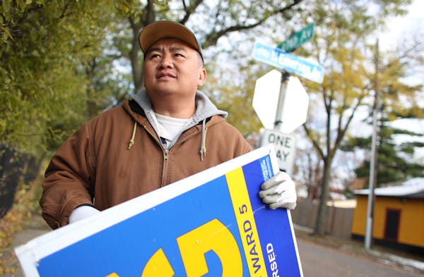 Blong Yang, newly elected Minneapolis City Council member, packed up his lawn signs on Wednesday, Nov. 6, 2013, in north Minneapolis. Yang will be the