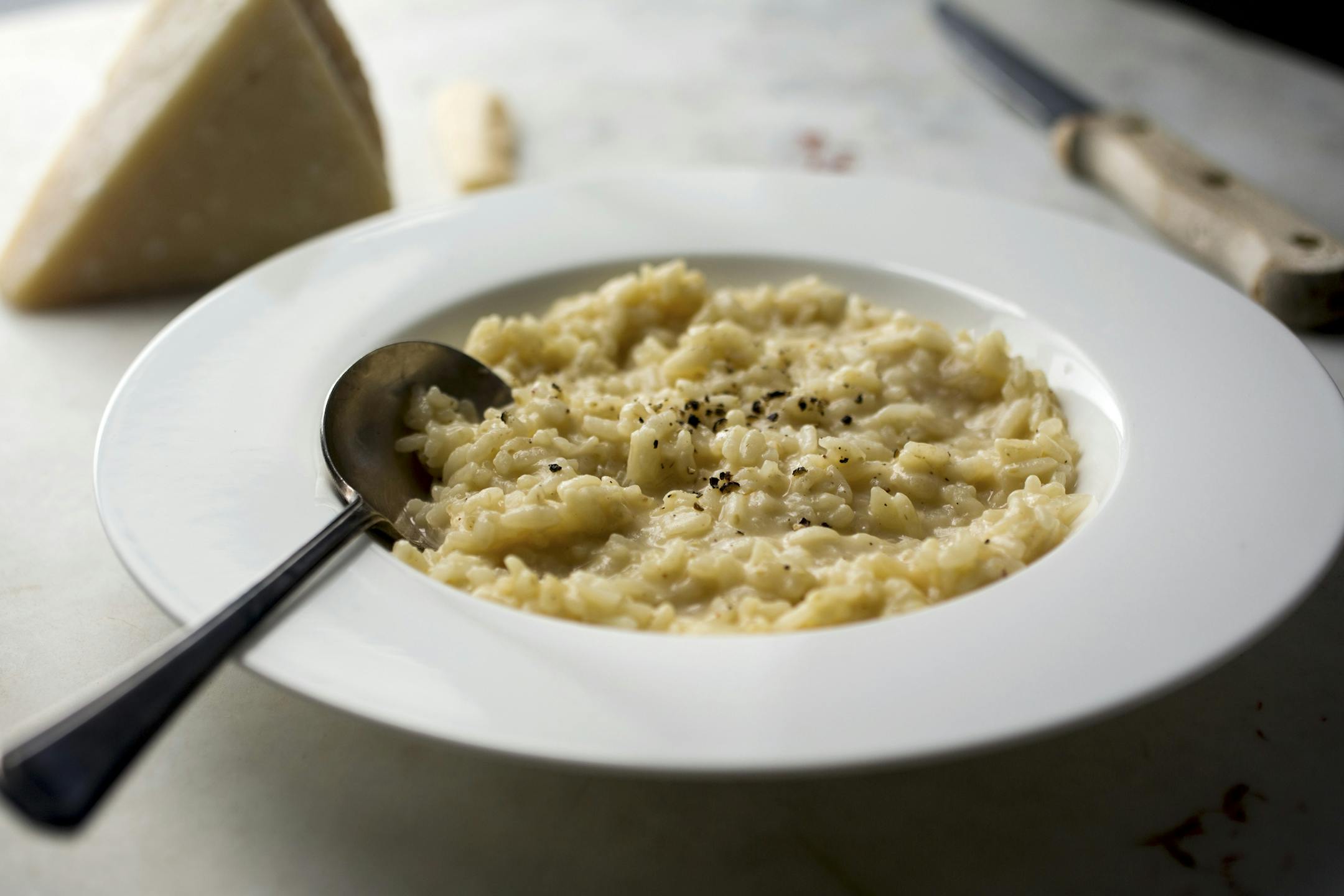 Parmesan broth risotto Milanese, in New York, Sept. 7, 2015. Risotto can only be as good as the stock -- chicken is a good choice -- used to slowly cook the rice. For a delicious vegetarian risotto, substitute a stock made with parmesan rinds. (Andrew Scrivani/The New York Times) ORG XMIT: XNYT16