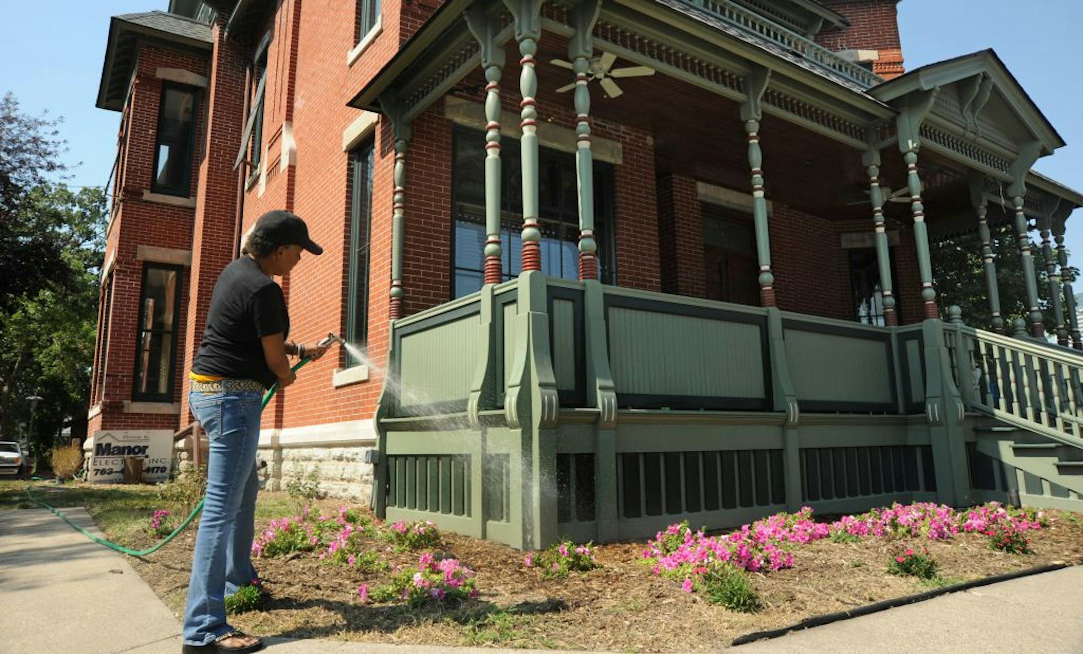 Founder Roxanne Givens washed the front porch of the former mansion that will be home to the Minnesota African American Museum. It is to open Sept. 15.