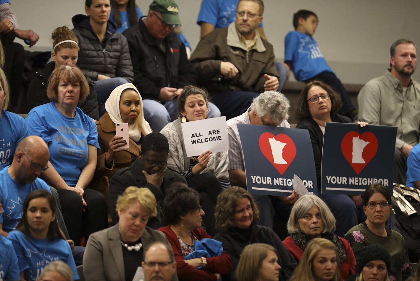 The City Council meeting drew more than 300 people, some carrying U.S. flags while others held signs that read "All Are Welcome."