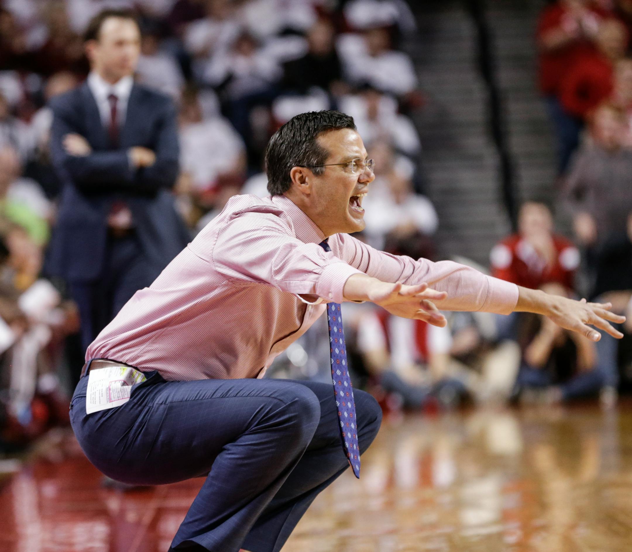 Nebraska coach Tim Miles calls a play as Minnesota coach Richard Pitino stands in the background during the first half of an NCAA college basketball game in Lincoln, Neb., Tuesday, Dec. 5, 2017. (AP Photo/Nati Harnik)