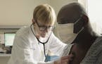 This photo provided by Netflix shows Dr. Lisa Sanders examining a patient in a scene from the new Netflix series &#x201c;Diagnosis,&#x201d; which tran