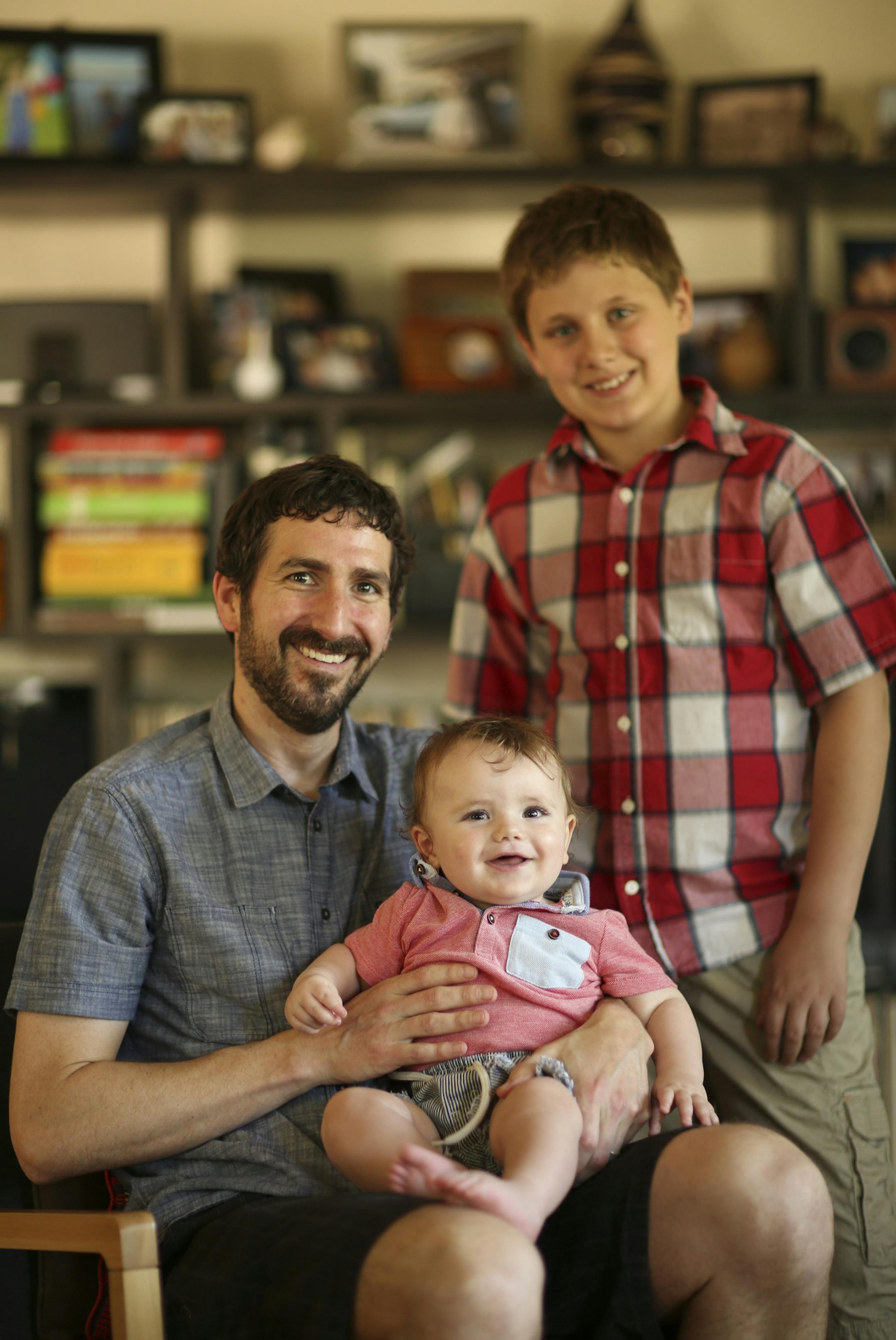 Phil Sheridan with his sons, Edrick and Leander ] JEFF WHEELER • jeff.wheeler@startribune.com Phil Sheridan adopted his wife's son, Leander, after they married. Then last year they had a child, Edrick, together. The three were photographed in their Minneapolis home Wednesday afternoon, May 28, 2014.