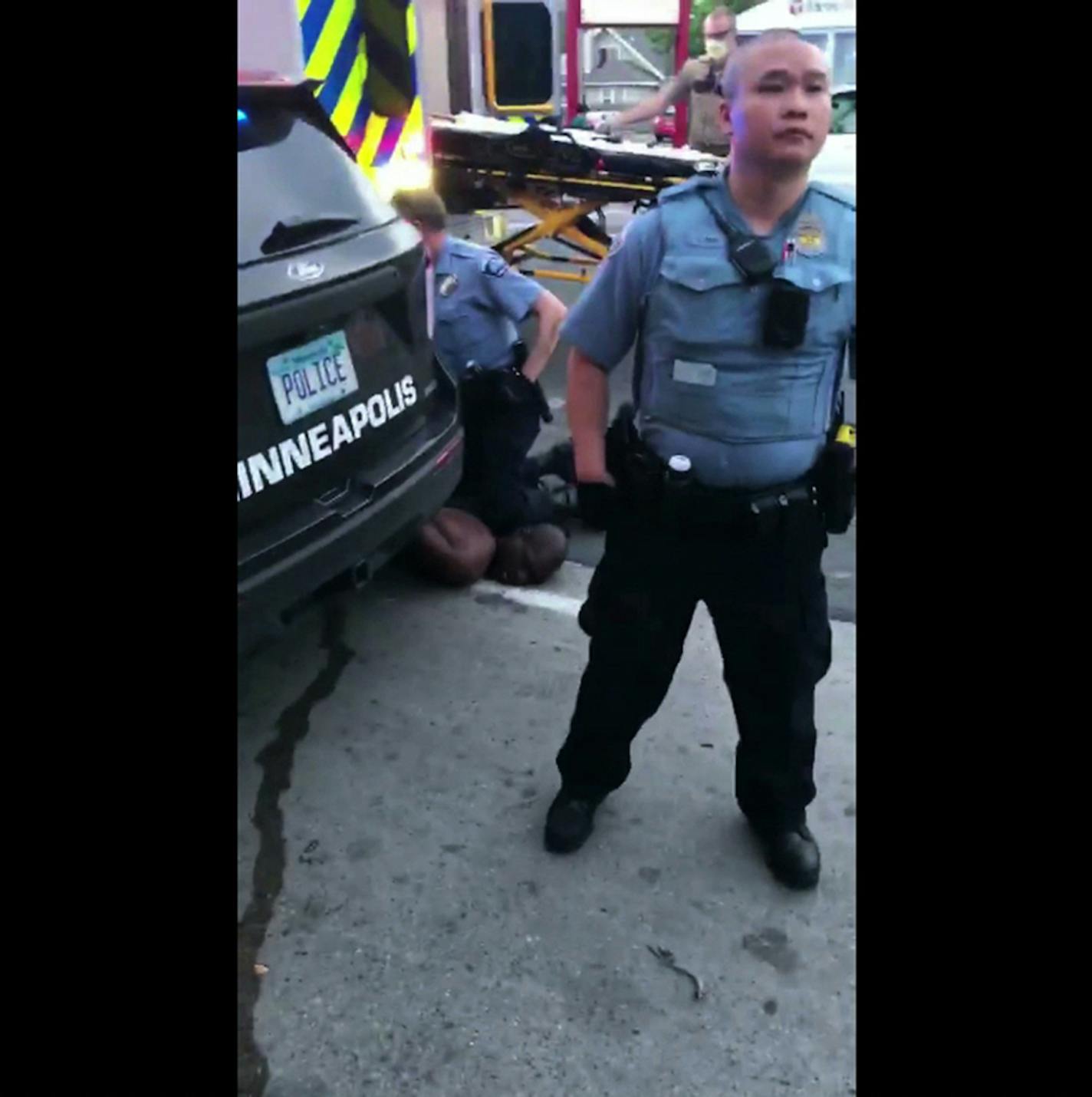 VIDEO FRAMEGRAB: The scene of George Floyd's May 25 killing, showing former officer Derek Chauvin kneeling on his neck as former officer Tou Thao works crowd control.