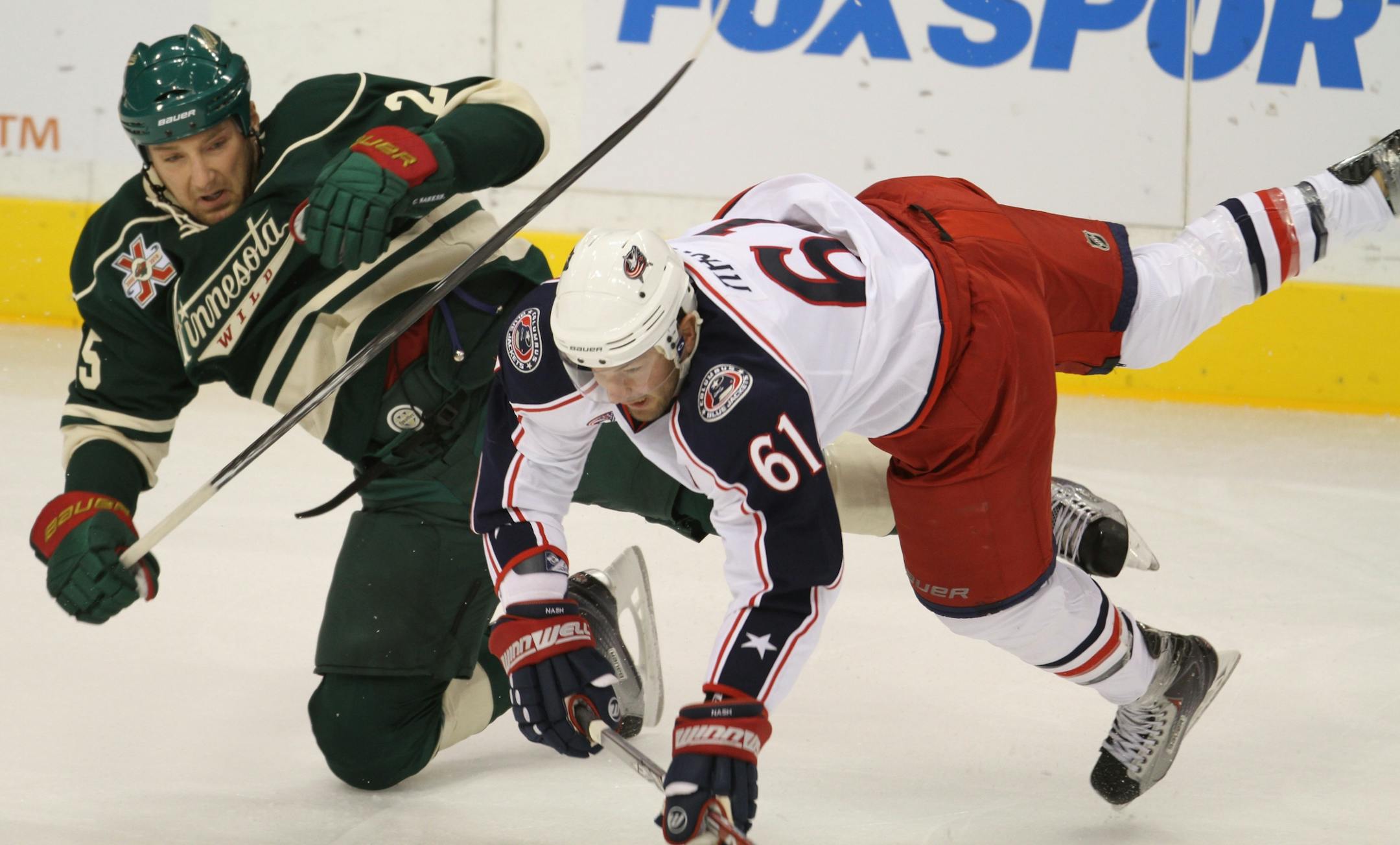 Wild's Cam Barker (left)