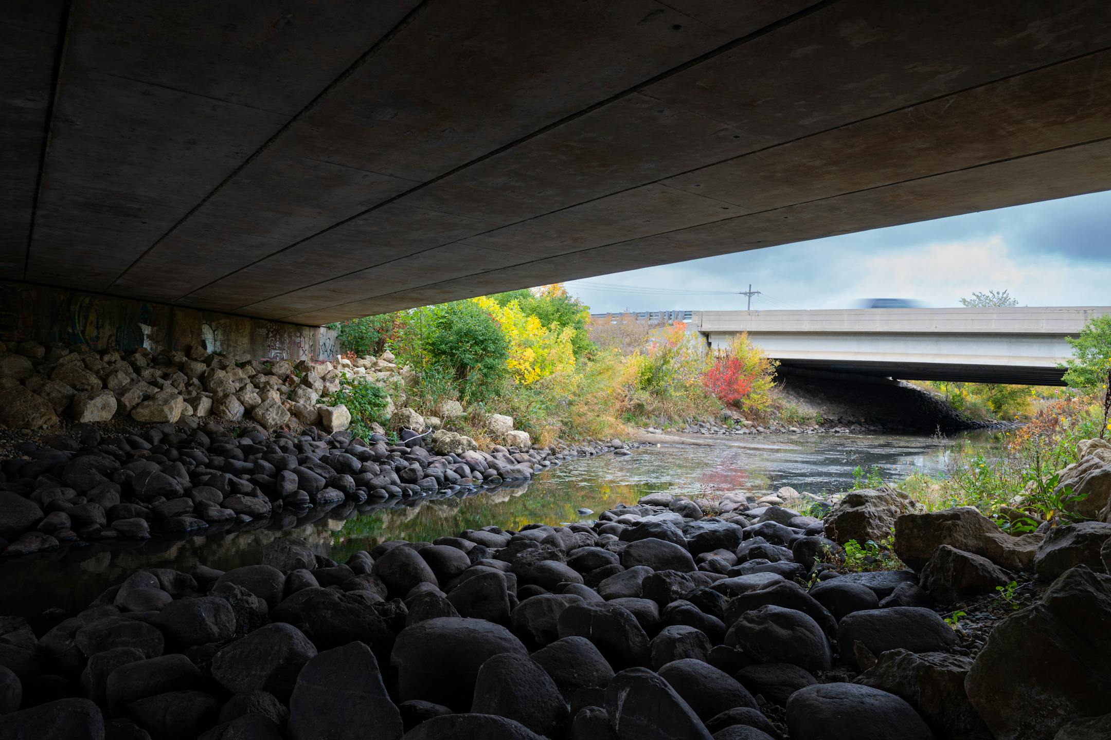 Minnehaha Creek flows beneath a bridge in Hopkins, Minn.