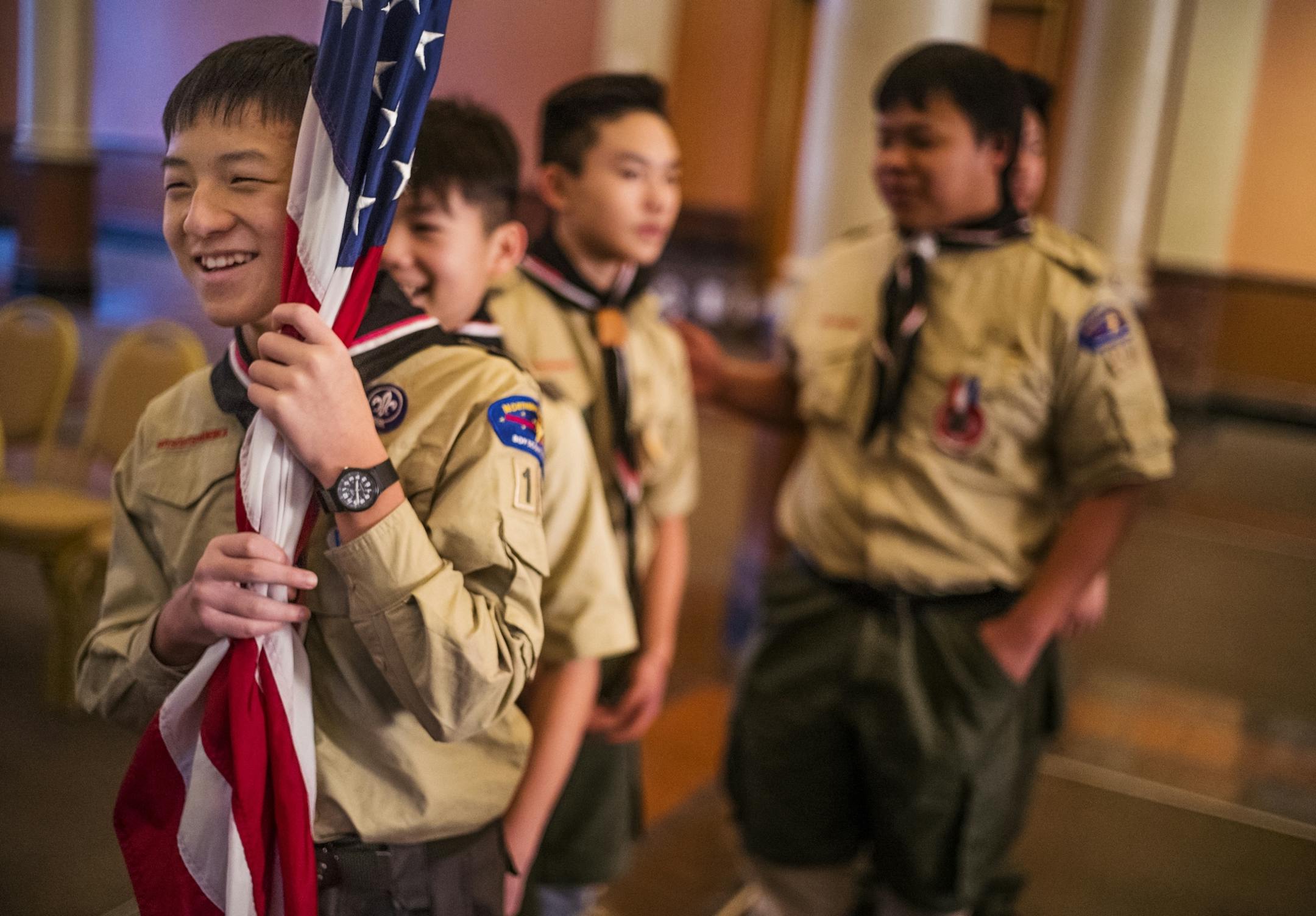 Jeffrey Vang,12, holds the American flag as his mostly Hmong Troop 100 gets ready for the flag ceremony.
